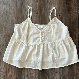 Cute white V-neck crop top with button details on front.